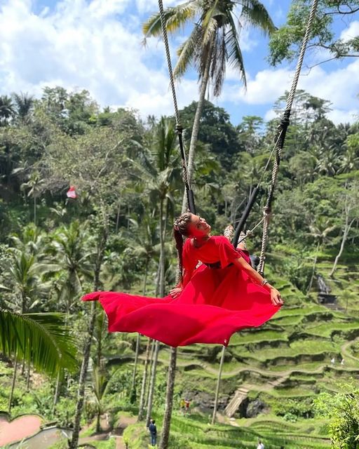 swing with a view of trees and rice fields at Uma Ceking Resto and Swings